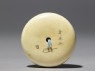 Manjū netsuke with a boy playing with a spinning top (back)