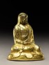 Seated figure of a monk with a robe draped over his head (side)