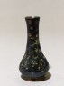 Black ware vase with yellow splashes (oblique)