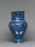 Jug with flowers against a fish-scale background (side)