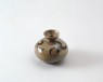 Greenware oil bottle with scroll decoration (oblique)