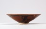 Black ware tea bowl with 'partidge feather' glazes (front)