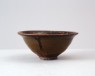 Black ware bowl with russet iron spots (oblique)