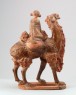 Figure of a camel carrying a young girl (oblique)