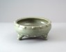 Greenware bowl with feet in the form of animal heads (oblique)